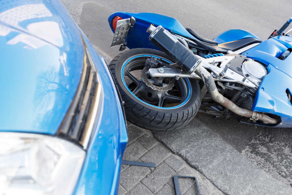 motorcycle and front end of a car after accident